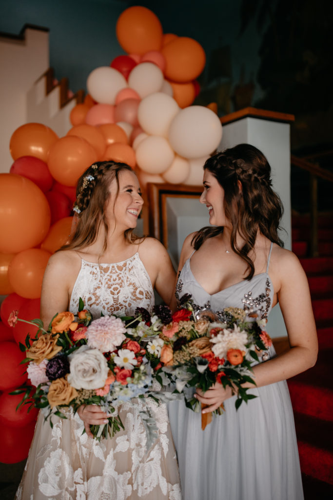 Bridesmaids with wedding florals and balloons
